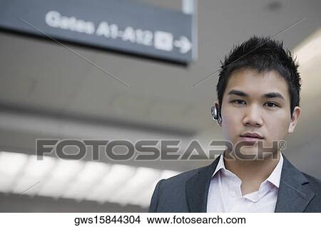 Portrait of a businessman wearing a bluetooth headset View Large Photo Image Picture - Portrait of a businessman wearing a bluetooth headset. Fotosearch