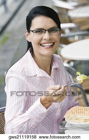 Portrait of a businesswoman having lunch at a sidewalk cafe View Large Photo Image Stock Photo - Portrait of a businesswoman having lunch at a sidewalk cafe. Fotosearch