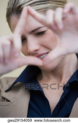 Portrait of a businesswoman looking through a finger frame View Large Photo Image Stock Photo - Portrait of a businesswoman looking through a finger frame. Fotosearch