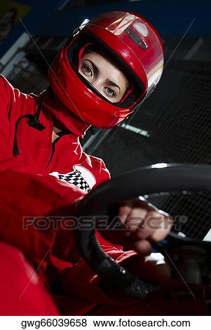 Stock Photo - Portrait of a female go-cart racer sitting in a sports car. Fotosearch