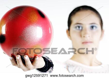 Portrait of a female gymnast holding a ball View Large Photo Image Stock Image - Portrait of a female gymnast holding a ball. Fotosearch