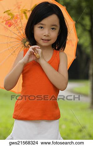 Portrait of a girl holding a parasol View Large Photo Image Picture - Portrait of a girl holding a parasol. Fotosearch