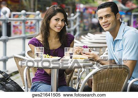 Portrait of a mid adult man proposing to a young woman at a sidewalk cafe View Large Photo Image Stock Photography - Portrait of a mid adult man proposing to a young woman at a sidewalk cafe. Fotosearch