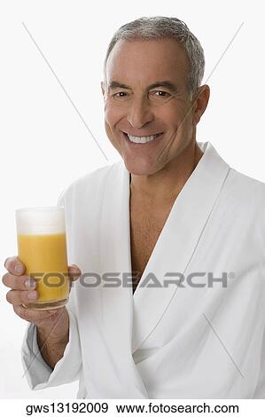 Portrait of a senior man holding a glass of orange juice and smiling View Large Photo Image Stock Photo - Portrait of a senior man holding a glass of orange juice and smiling. Fotosearch