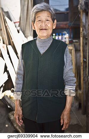 Portrait of a senior woman standing, HohHot, Inner Mongolia, China View Large Photo Image Picture - Portrait of a senior woman standing, HohHot, Inner Mongolia, China. Fotosearch