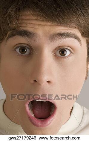 Portrait of a young man looking surprised View Large Photo Image Stock Photograph - Portrait of a young man looking surprised. Fotosearch