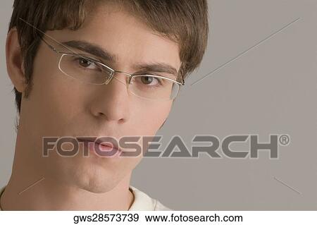 Stock Photo - Portrait of a young man thinking. Fotosearch