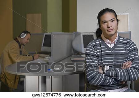 Portrait of a young man with his arms crossed View Large Photo Image Stock Photograph - Portrait of a young man with his arms crossed. Fotosearch