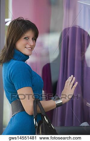 Portrait of a young woman window shopping View Large Photo Image Stock Image - Portrait of a young woman window shopping. Fotosearch