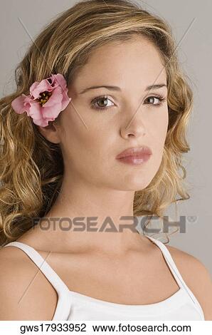 Portrait of a young woman with a flower in her hair View Large Photo Image Stock Image - Portrait of a young woman with a flower in her hair. Fotosearch