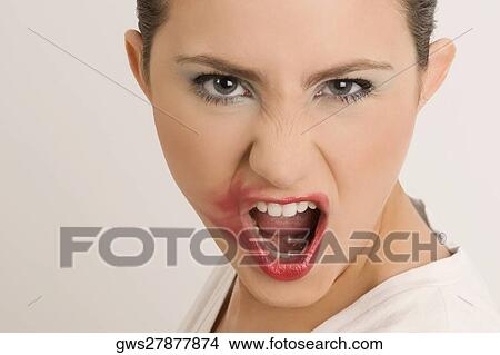 Picture - Portrait of a young woman with her messy lips. Fotosearch