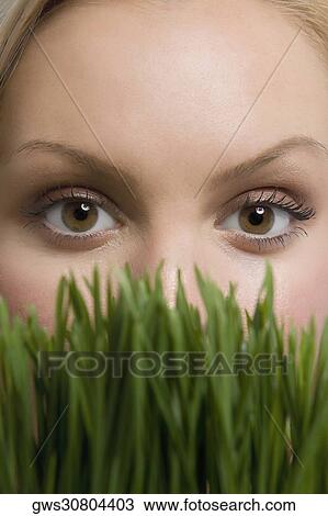 Portrait of a young woman with wheatgrass View Large Photo Image Stock Image - Portrait of a young woman with wheatgrass. Fotosearch