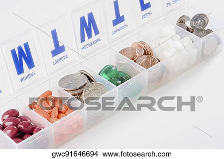 Prescription medication schedule box containing coins and capsules View Large Photo Image Picture - Prescription medication schedule box containing coins and capsules. Fotosearch