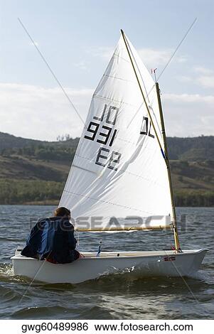 Rear view of a person participating in a sailboat race View Large Photo Image Stock Photograph - Rear view of a person participating in a sailboat race. Fotosearch