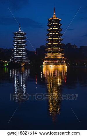 Reflection of pagodas in a lake, Sun And Moon Pagoda, Banyan Lake, Guilin, Guangxi Province, China View Large Photo Image Picture - Reflection of pagodas in a lake, Sun And Moon Pagoda, Banyan Lake, Guilin, Guangxi Province, China. Fotosearch