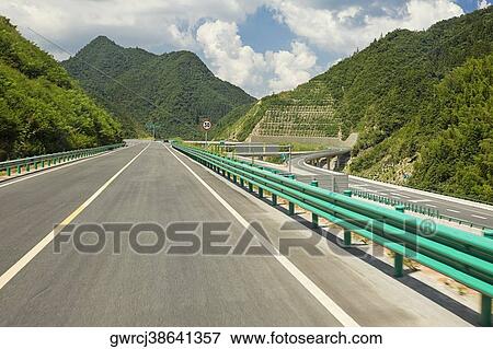 Road passing through mountains, Huangshan Mountains, Anhui Province, China View Large Photo Image Stock Photo - Road passing through mountains, Huangshan Mountains, Anhui Province, China. Fotosearch