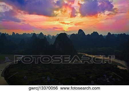 Stock Photograph - Rock formations on a landscape, Li River, XingPing, Yangshuo, Guangxi Province, China. Fotosearch