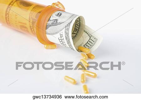 Roll of US one hundred dollar bills inside a pill bottle with capsule View Large Photo Image Stock Photograph - Roll of US one hundred dollar bills inside a pill bottle with capsule. Fotosearch