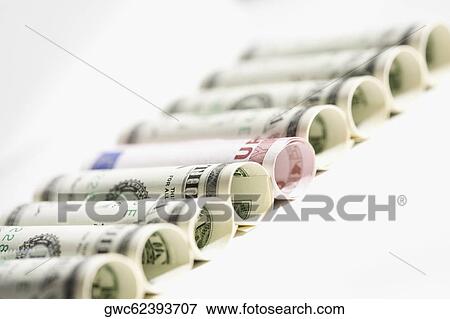 Rolls of US paper currency with European union euro note View Large Photo Image Stock Photo - Rolls of US paper currency with European union euro note. Fotosearch