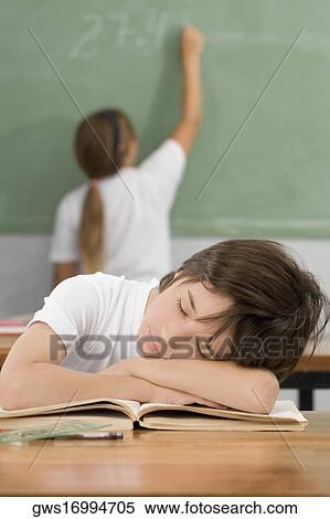 Schoolboy napping on a desk in a classroom View Large Photo Image Stock Photography - Schoolboy napping on a desk in a classroom. Fotosearch