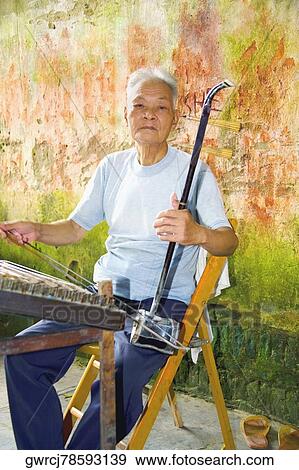 Senior man playing erhu, Fuli Village, Yangshuo, Guangxi Province, China View Large Photo Image Stock Photo - Senior man playing erhu, Fuli Village, Yangshuo, Guangxi Province, China. Fotosearch