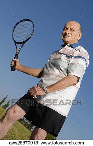 Senior man playing tennis View Large Photo Image Stock Photo - Senior man playing tennis. Fotosearch
