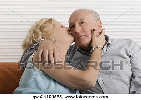 Senior woman kissing a senior man View Large Photo Image Stock Photography - Senior woman kissing a senior man. Fotosearch