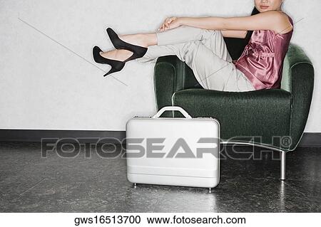 Side profile of a businesswoman sitting in an armchair View Large Photo Image Stock Image - Side profile of a businesswoman sitting in an armchair. Fotosearch