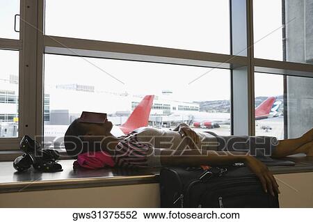Side profile of a businesswoman sleeping at an airport View Large Photo Image Stock Image - Side profile of a businesswoman sleeping at an airport. Fotosearch