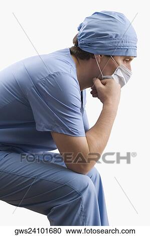 Stock Image - Side profile of a male surgeon thinking. Fotosearch