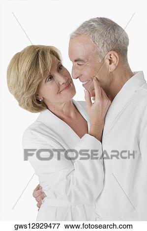 Side profile of a senior man embracing a mature woman and smiling View Large Photo Image Stock Photo - Side profile of a senior man embracing a mature woman and smiling. Fotosearch