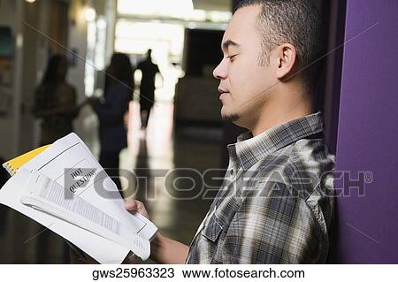 Side profile of a young man reading a book View Large Photo Image Stock Image - Side profile of a young man reading a book. Fotosearch