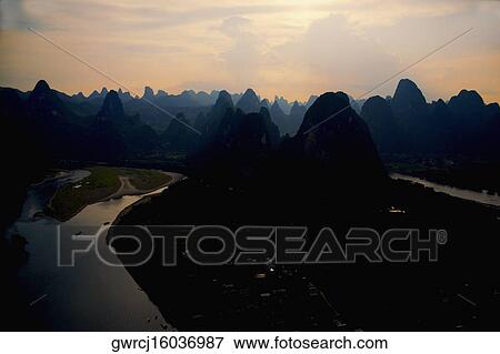 Stock Photo - Silhouette of a hill range at dusk, Guilin Hills, XingPing, Yangshuo, Guangxi Province, China. Fotosearch