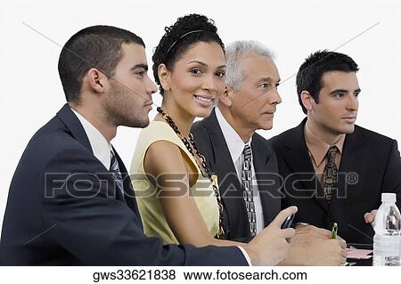 Three businessmen and a businesswoman at a meeting in a conference room View Large Photo Image Stock Photo - Three businessmen and a businesswoman at a meeting in a conference room. Fotosearch