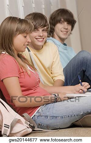 Three high school students sitting in a corridor View Large Photo Image Stock Photo - Three high school students sitting in a corridor. Fotosearch