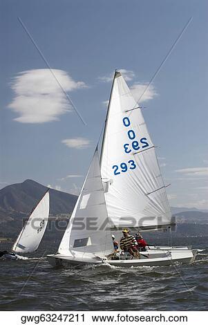 Three people participating in a sailboat race View Large Photo Image Stock Image - Three people participating in a sailboat race. Fotosearch
