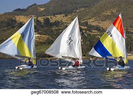 Stock Photo - Three people participating in a sailboat race. Fotosearch