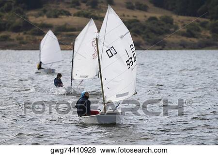 Three people participating in a sailboat race View Large Photo Image Stock Photo - Three people participating in a sailboat race. Fotosearch
