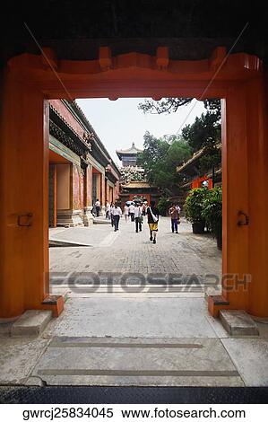 Stock Photography - Tourists walking in the courtyard of a palace, Forbidden City, Beijing, China. Fotosearch
