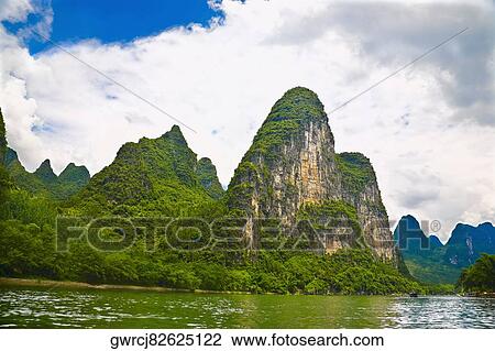 Stock Image - Trees at the riverside, Li River, XingPing, Yangshuo, Guangxi Province, China. Fotosearch