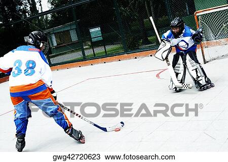Two boys playing ice hockey View Large Photo Image Stock Image - Two boys playing ice hockey. Fotosearch
