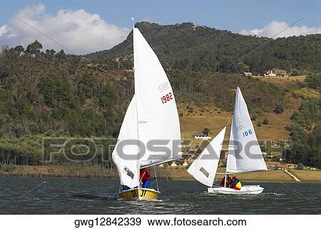 Two people participating in a sailboat race View Large Photo Image Stock Photo - Two people participating in a sailboat race. Fotosearch
