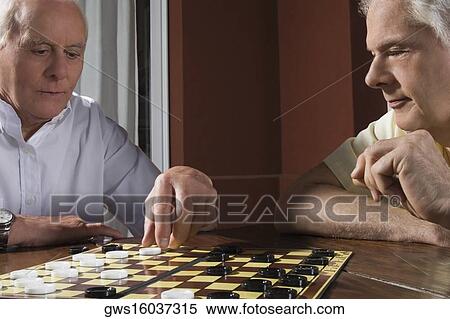 Two senior men playing checkers View Large Photo Image Stock Photography - Two senior men playing checkers. Fotosearch