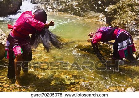 Two women washing hair at a waterfall, Jinkeng Terraced Field, Guangxi Province, China View Large Photo Image Stock Photo - Two women washing hair at a waterfall, Jinkeng Terraced Field, Guangxi Province, China. Fotosearch