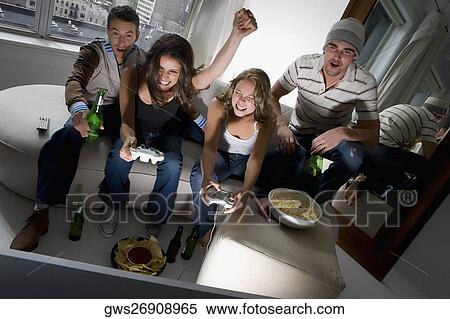 Two young couples playing video game and smiling View Large Photo Image Stock Photography - Two young couples playing video game and smiling. Fotosearch