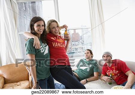 Two young women dancing with two young men looking at them View Large Photo Image Stock Photo - Two young women dancing with two young men looking at them. Fotosearch