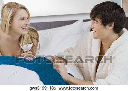 Young couple smiling at each other View Large Photo Image Stock Photography - Young couple smiling at each other. Fotosearch