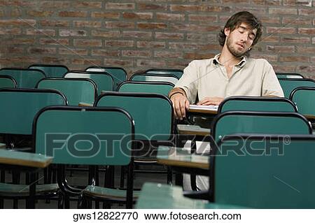 Young man napping in a classroom View Large Photo Image Stock Image - Young man napping in a classroom. Fotosearch