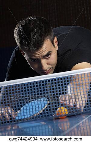 Young man playing table tennis View Large Photo Image Picture - Young man playing table tennis. Fotosearch