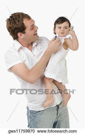 Young man playing with his daughter View Large Photo Image Stock Image - Young man playing with his daughter. Fotosearch